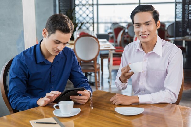 Two Young Business Partners Having Coffee Break