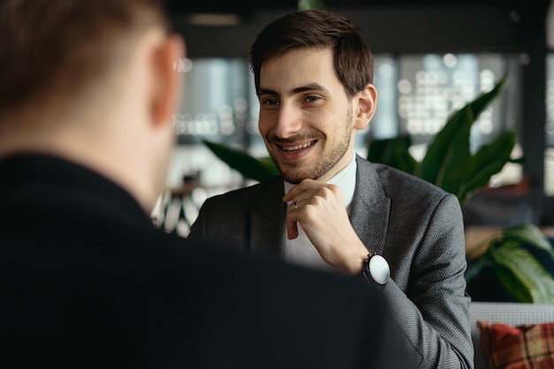 Two young businessmen discussing something