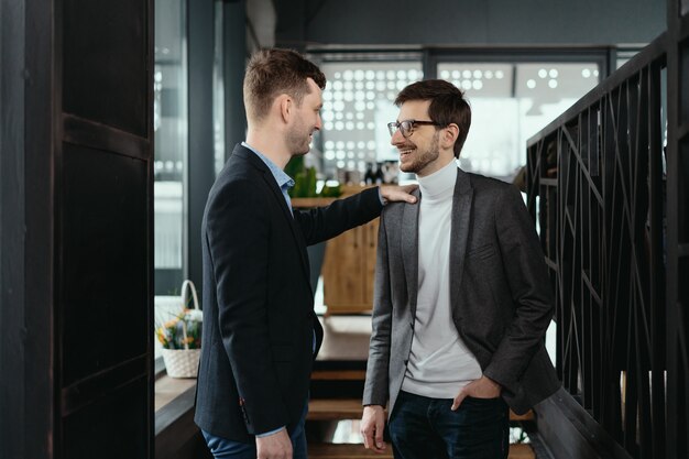 Two young businessmen greeting each other, shaking hand