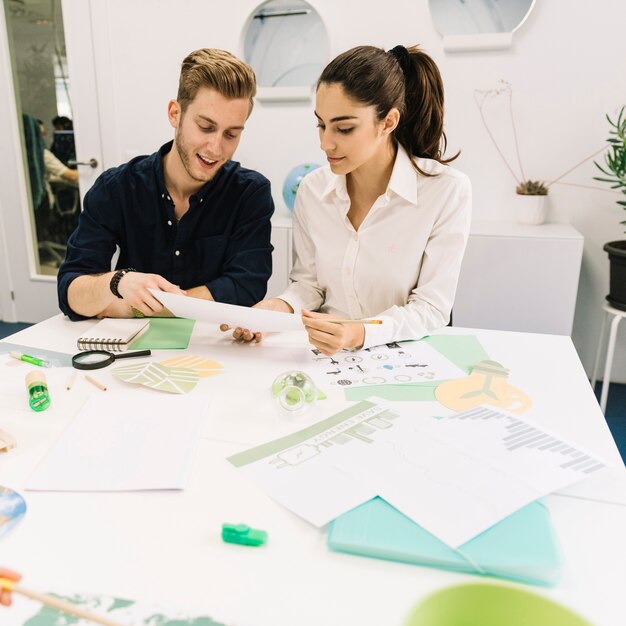 Two young businesspeople working in office