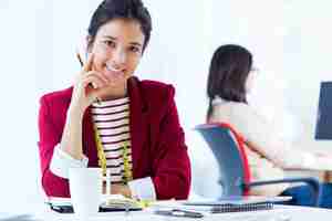 Free photo two young businesswomen working in her office.