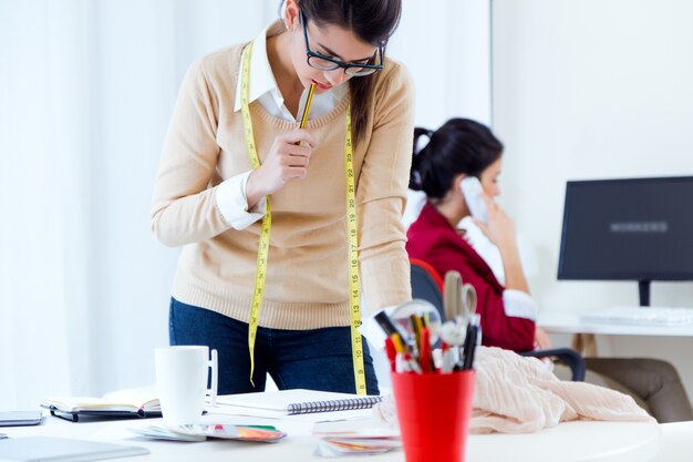 Two young businesswomen working in her office.