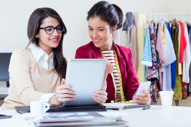 Free Photo | Two young businesswomen working with digital tablet in her ...