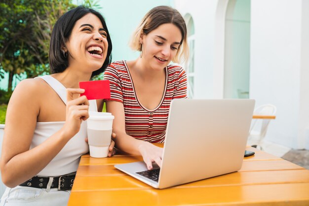 Two young friends doing shop online.