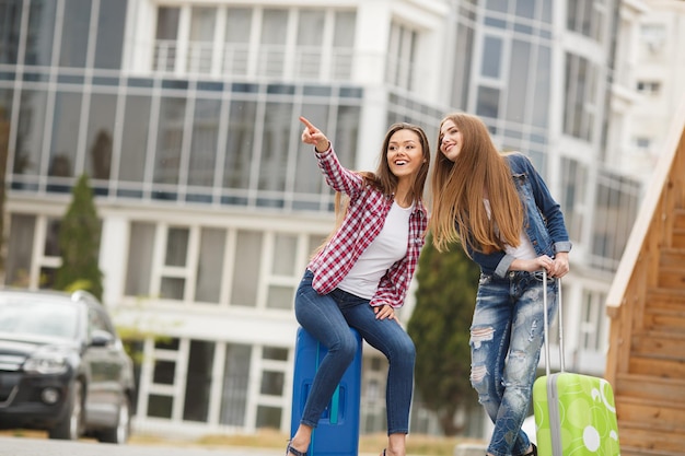 Two young friends traveller with suitcase