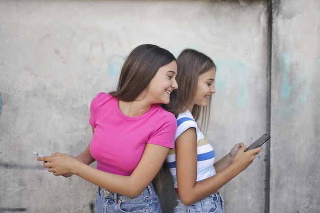 two young girls use the smartphone