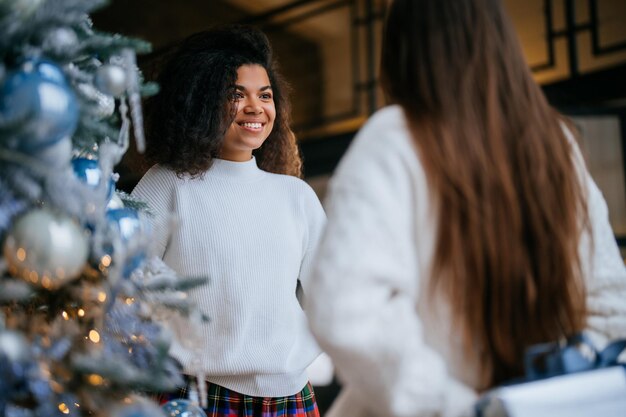 Two young and happy best friends a roommates exchange gifts