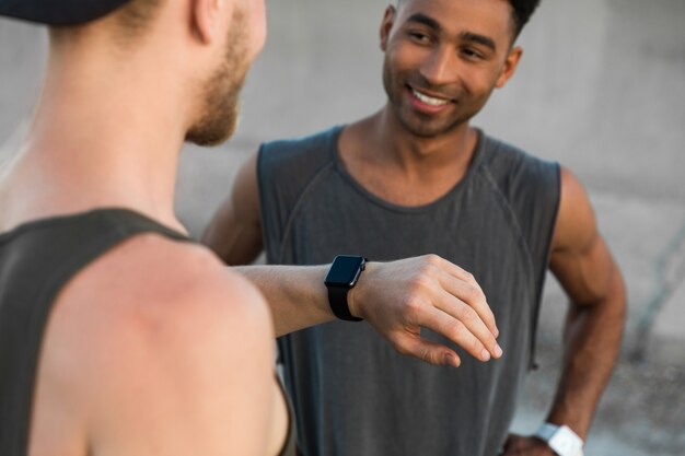 Two young men resting after running workout