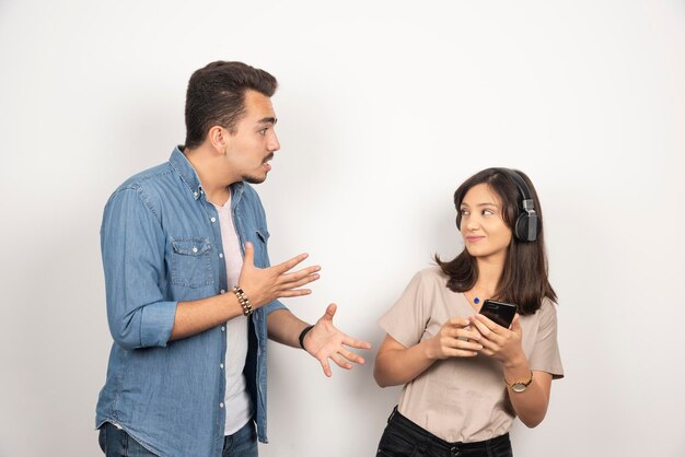 Two young people having argue about music.