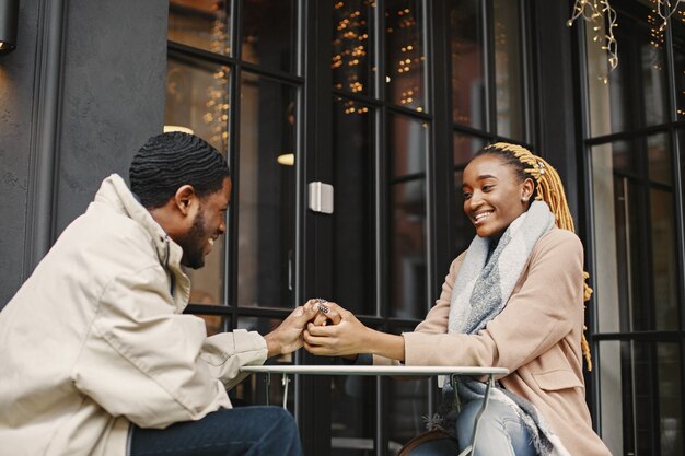 Two young people sitting outside. African couple enjoying the time spending with each other.