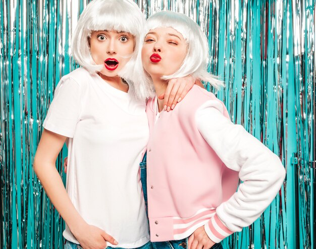 Two young sexy smiling hipster girls in white wigs and red lips.Beautiful trendy women in summer clothes summer 