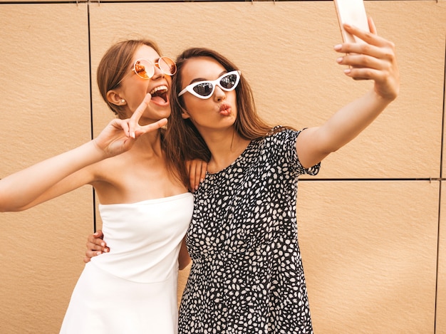 Free photo two young smiling hipster women in summer clothes.