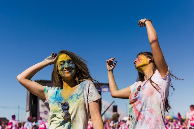 Two young women dancing during holi festival