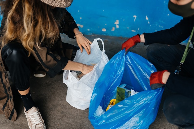 Two young women sorting garbage. Concept of recycling. Zero waste