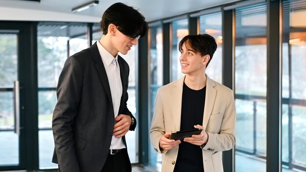 Free photo two young workers discussing business affairs in an office