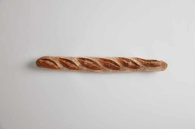 Typical French bread. Long thin appetizing baguette with perfect aroma, crisp crust, just baked in bakery, commonly made from basic lean dough, can be sliced or added to your dishes. Bakery concept