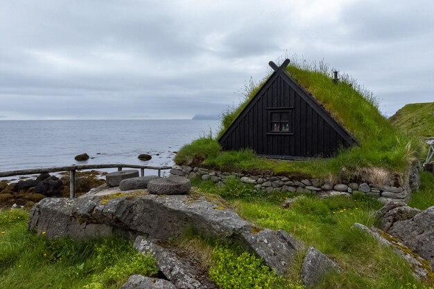 Typical Icelandic fishing village with grass-roofed homes and fish drying racks