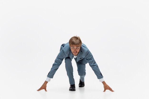 Typing. Man in office clothes running, jogging on white space like professional athlete, sportsman. Unusual look for businessman in motion, action with ball. Sport, healthy lifestyle, creativity.