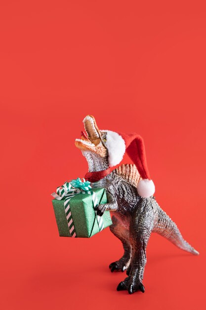 Tyrannosaurus rex toy holding gift box