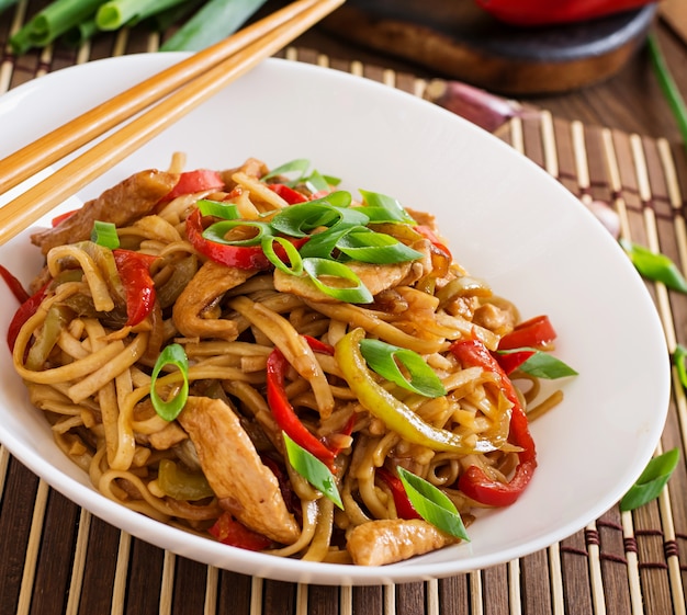 Udon noodles with chicken and peppers. Japanese cuisine