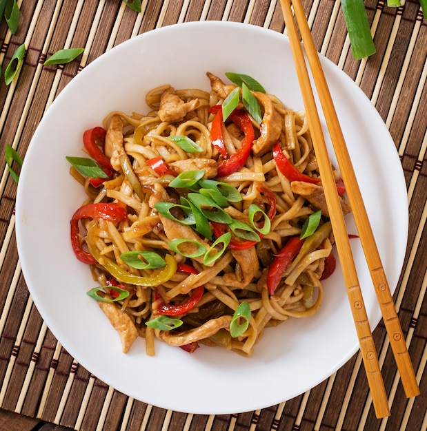 Udon noodles with chicken and peppers. Japanese cuisine