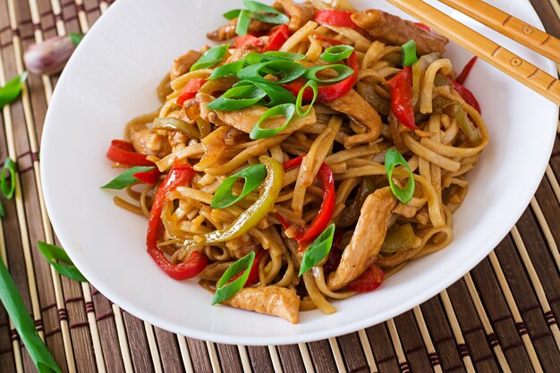 Udon noodles with chicken and peppers. Japanese cuisine