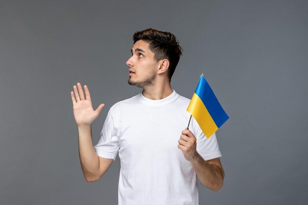 Ukraine russian conflict cute handsome guy in white shirt with ukrainian flag