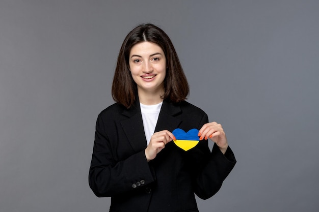 Ukraine russian conflict cute young dark hair woman in black blazer brave with heart