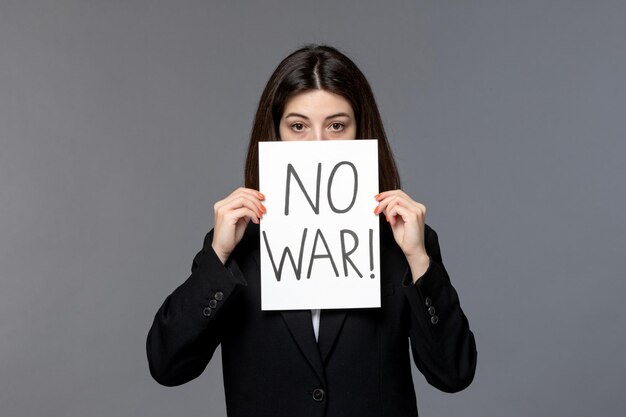 Ukraine russian conflict dark hair cute young woman in black blazer covering face no war sign