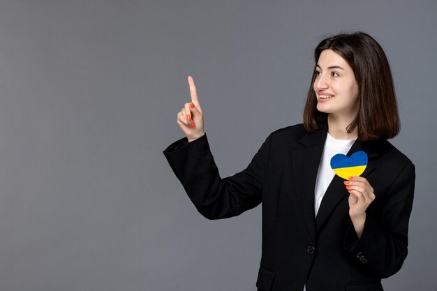 Ukraine russian conflict gorgeous young dark hair woman in black blazer pointing up