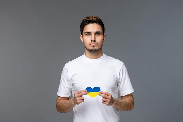 Ukraine russian conflict pretty cute handsome man in white shirt with ukrainian flag