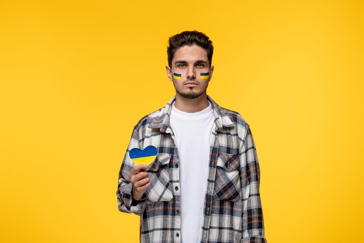 Free Photo ukraine russian conflict strong young cute brave guy with flags on cheeks