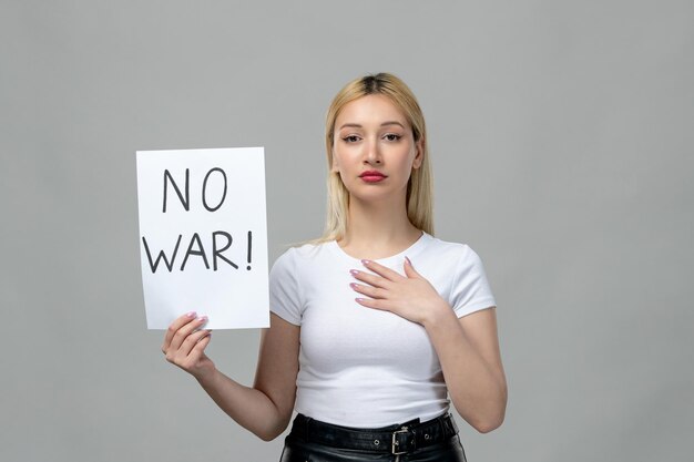 Ukraine russian conflict young cute girl holding no war sign holding chest