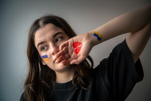 ukrainian girl with a broken heart drawn on her hand pain for ukraine