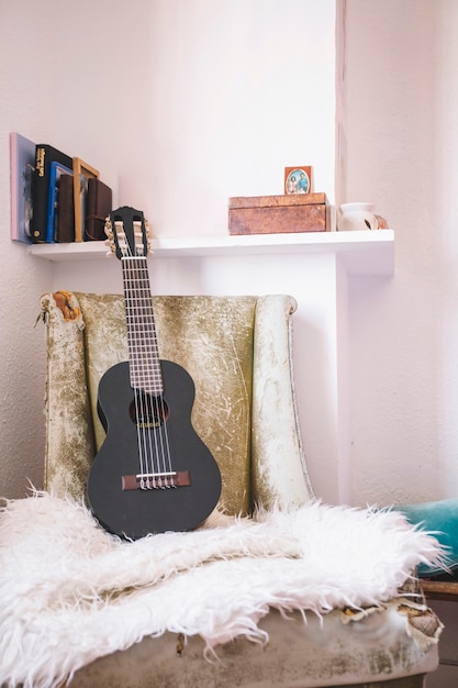 Free photo ukulele lying on chair