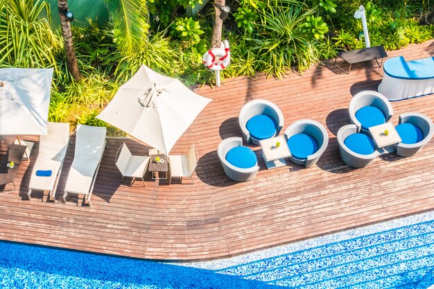 Umbrella and chair around beautiful luxury swimming pool