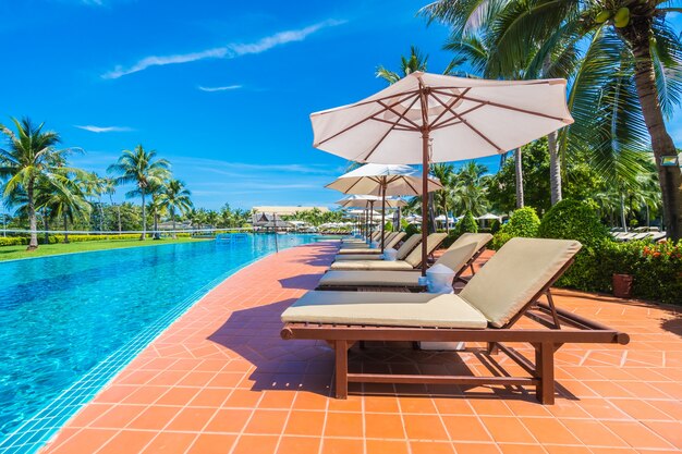 Umbrella and chair around swimming pool