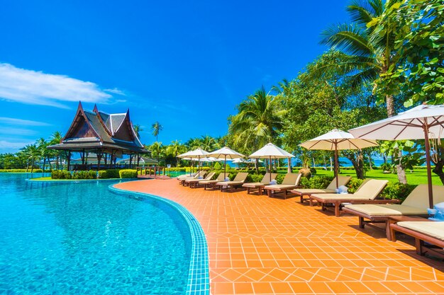 Umbrella and chair around swimming pool