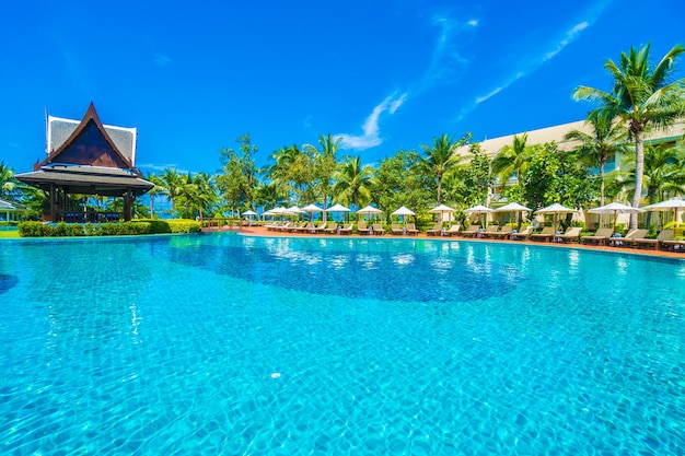 Umbrella and chair around swimming pool