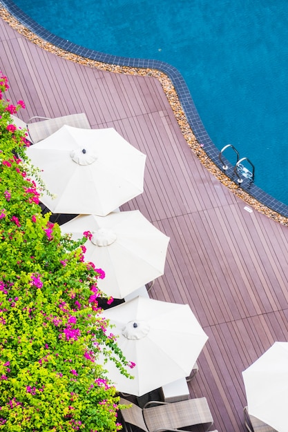 Foto gratuita ombrellone e sedia intorno piscina