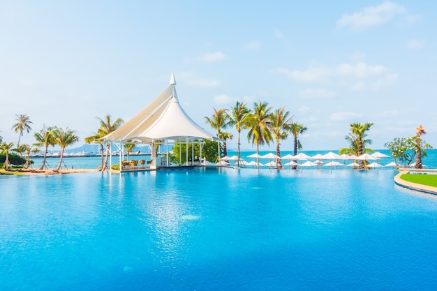 Umbrella and chair around swimming pool