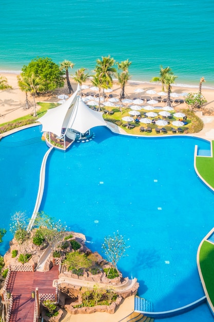 Umbrella and chair around swimming pool