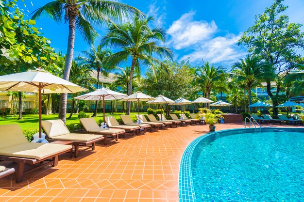 Umbrella and chair around swimming pool