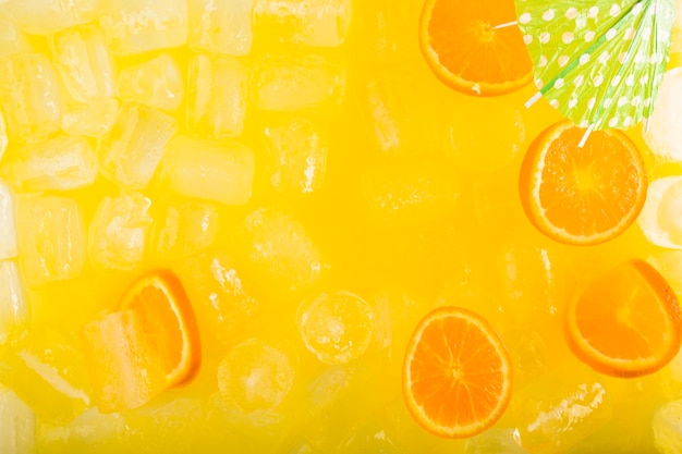 Umbrella and citruses in tasty drink