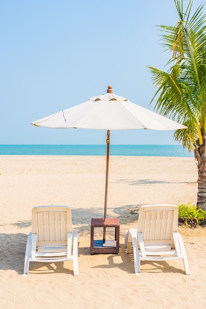 Umbrella and deck chairs around beach