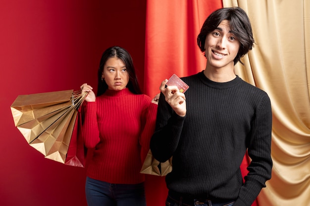 Unamused woman posing with man for chinese new year