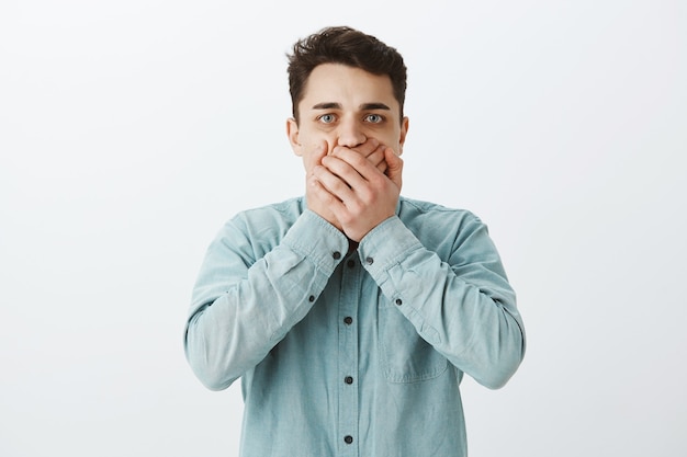 Free photo uncomfortable worried caucasian man in shirt