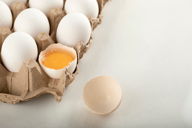 Uncooked chicken eggs in a carton container. 