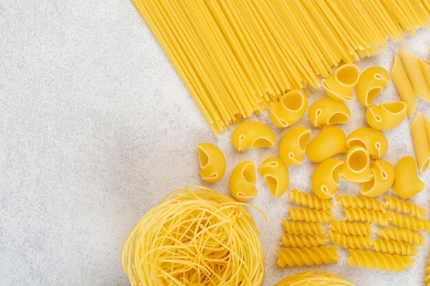 Uncooked fresh macaroni on white space