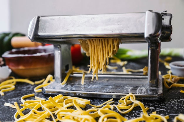 Delicious Uncooked Noodles and Pasta Machine